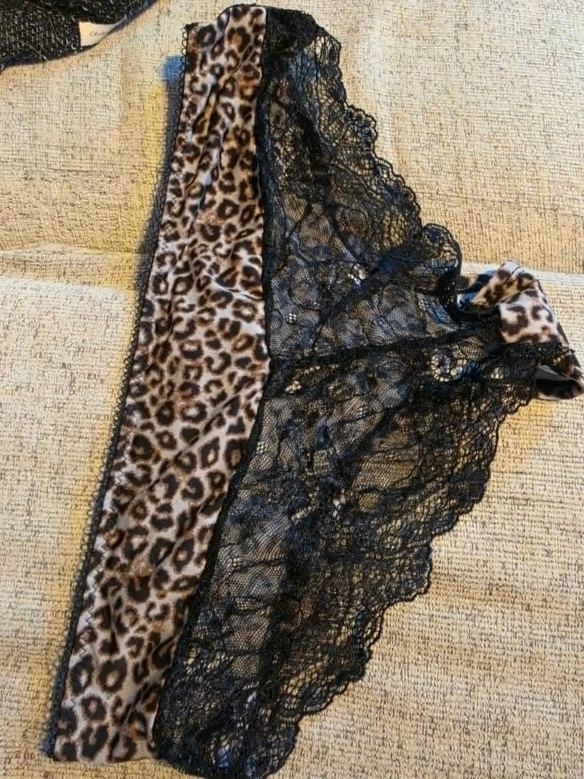 Sexy leopard print panties featuring delicate black lace trim and pink bow